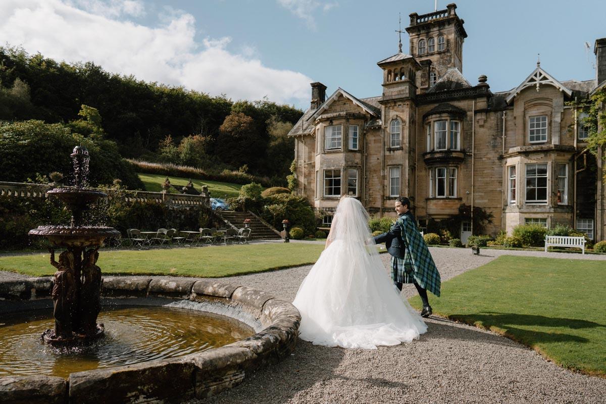 Wedding couple in Italianate garden at front of Auchen Castle