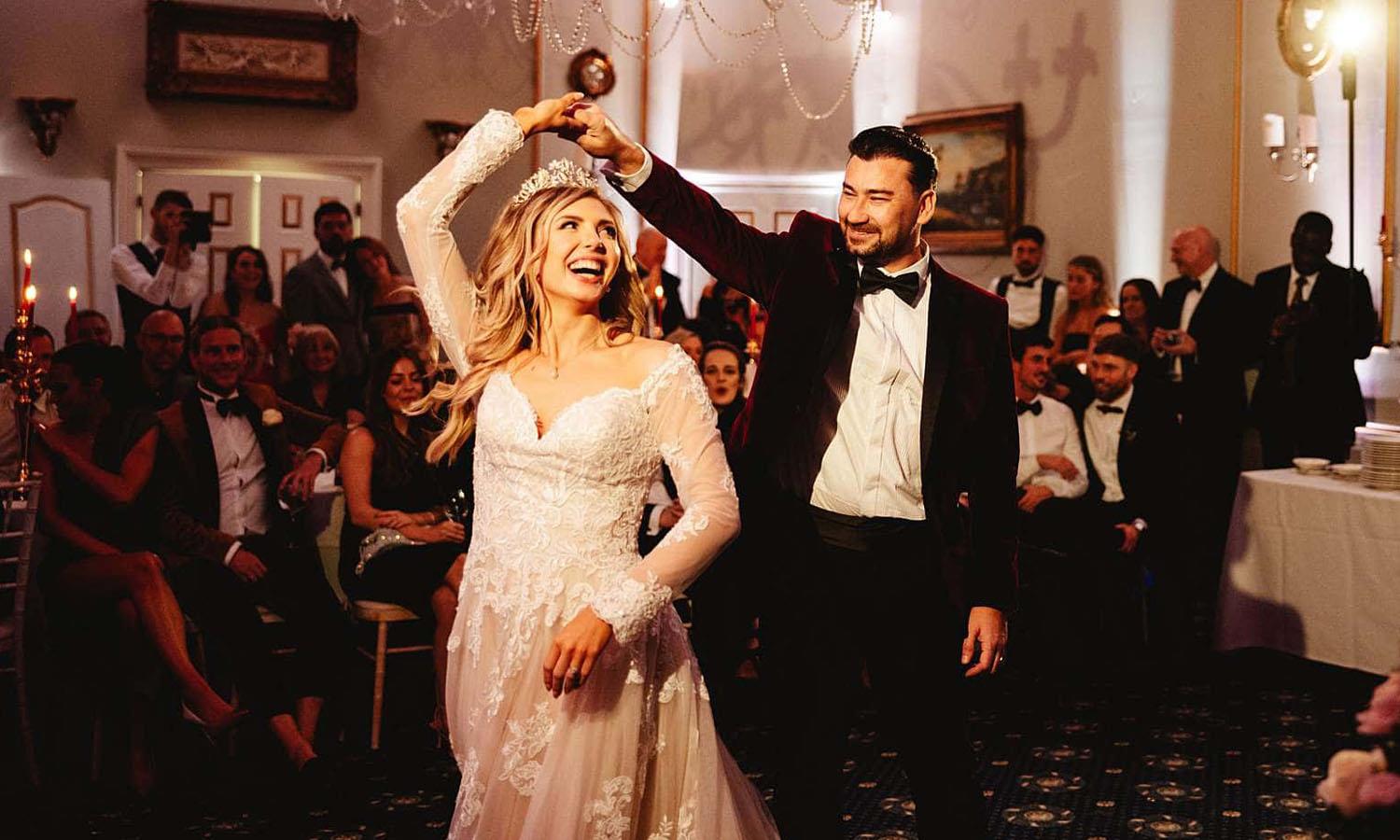 Bride and groom celebrating in Melville Castle's ballroom