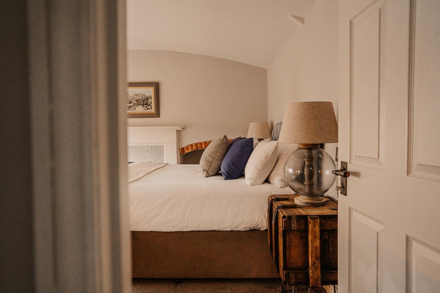 Premium Room at Ship Inn featuring bed , cushions and lamp