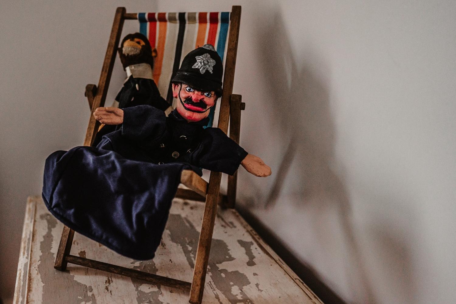 Police puppet in deckchair