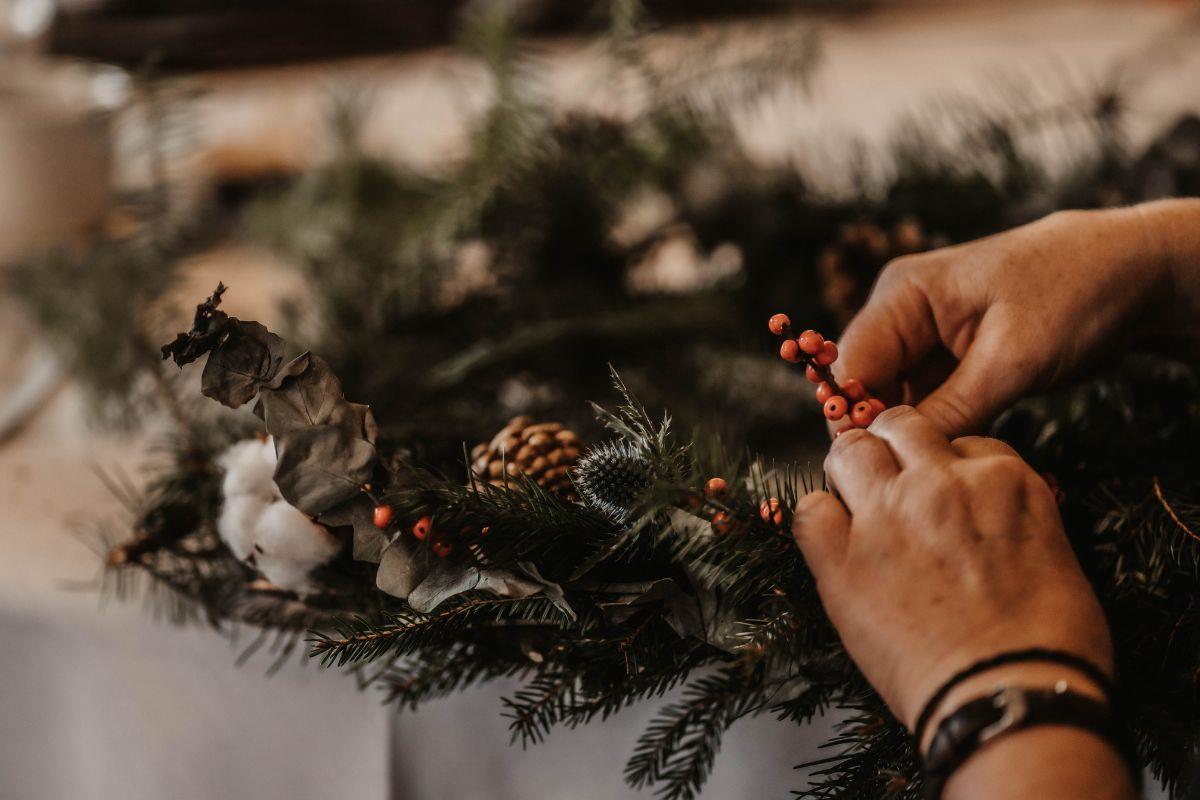 Final touches are made to a Christmas wreath