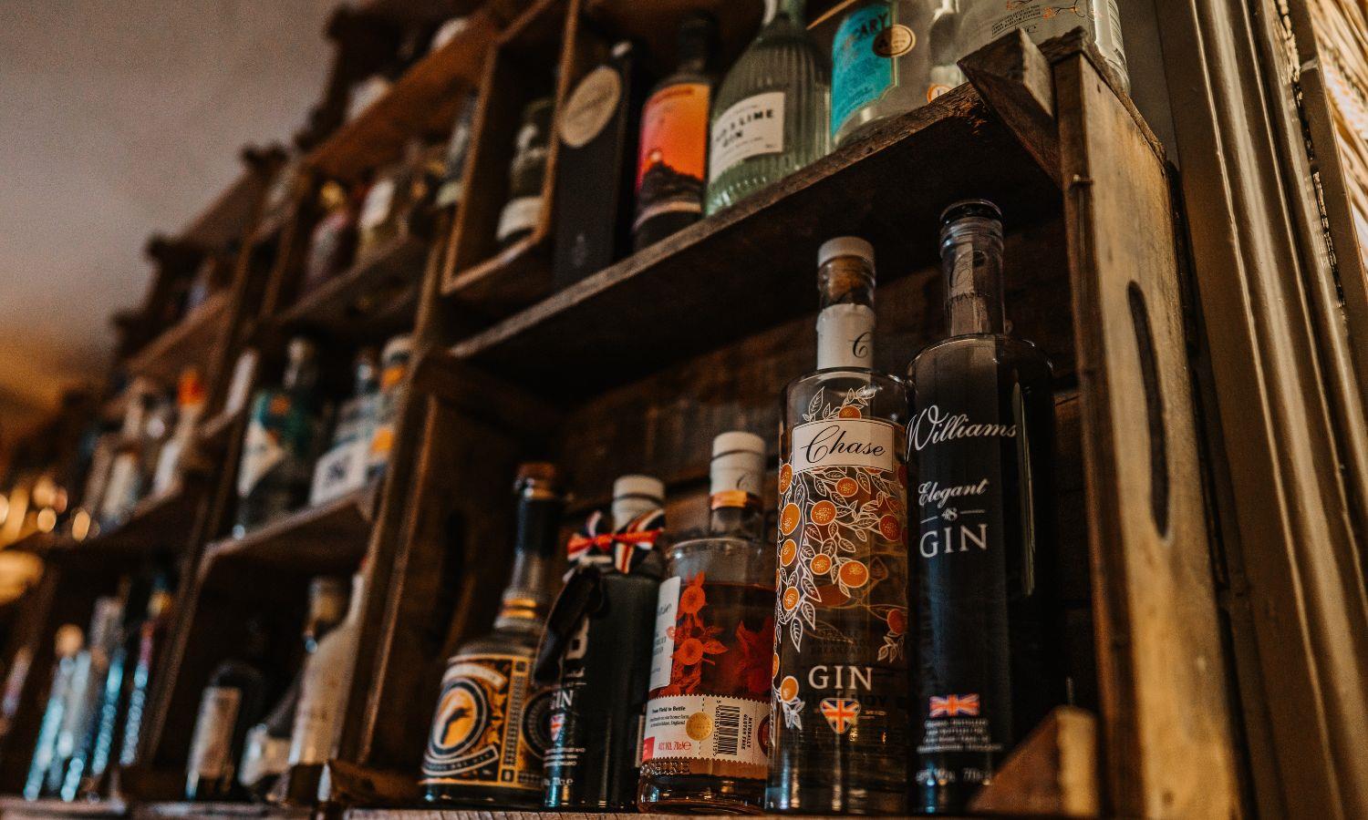 Shelves of gin behind bar