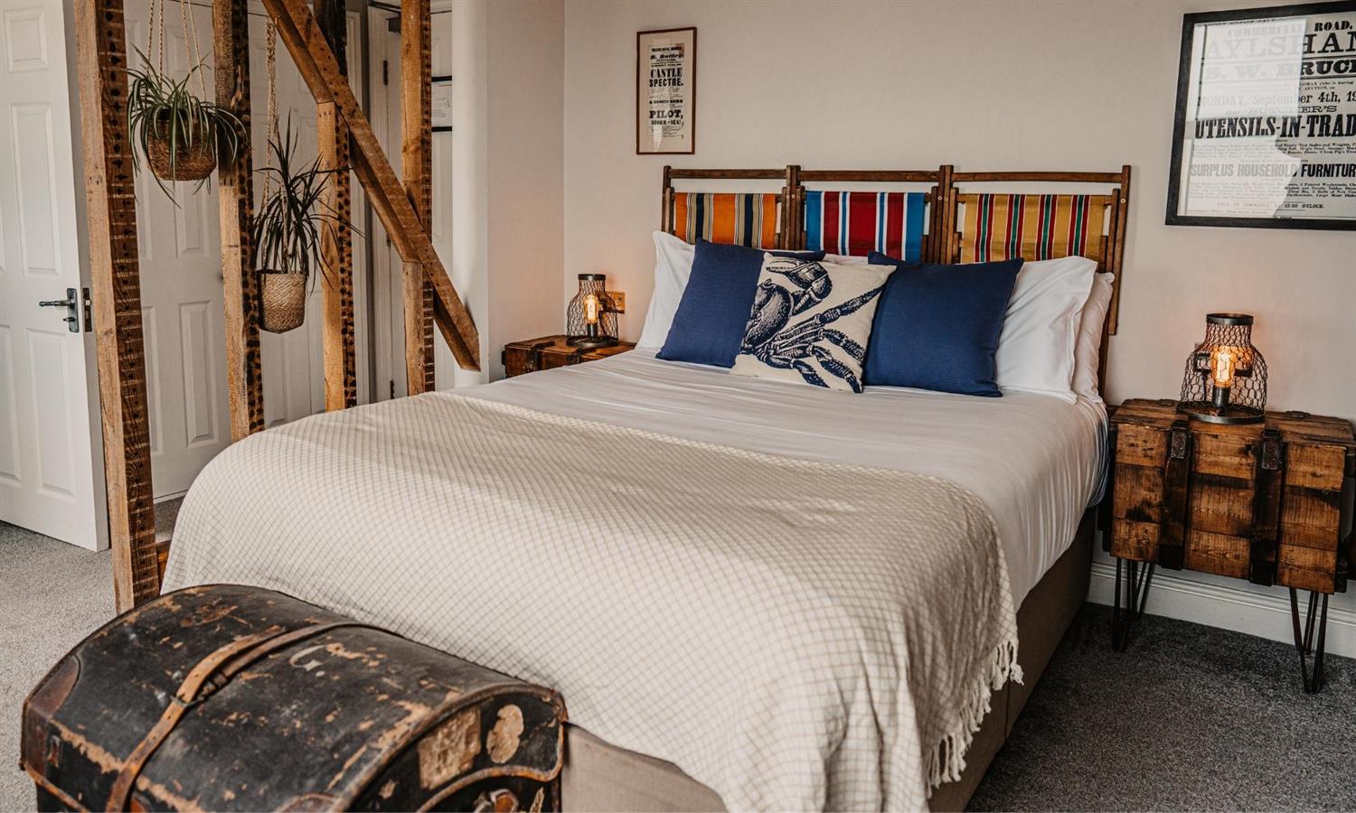 Deluxe Sea View Bedroom at The Ship Inn with bed, cushions and deckchair headboard