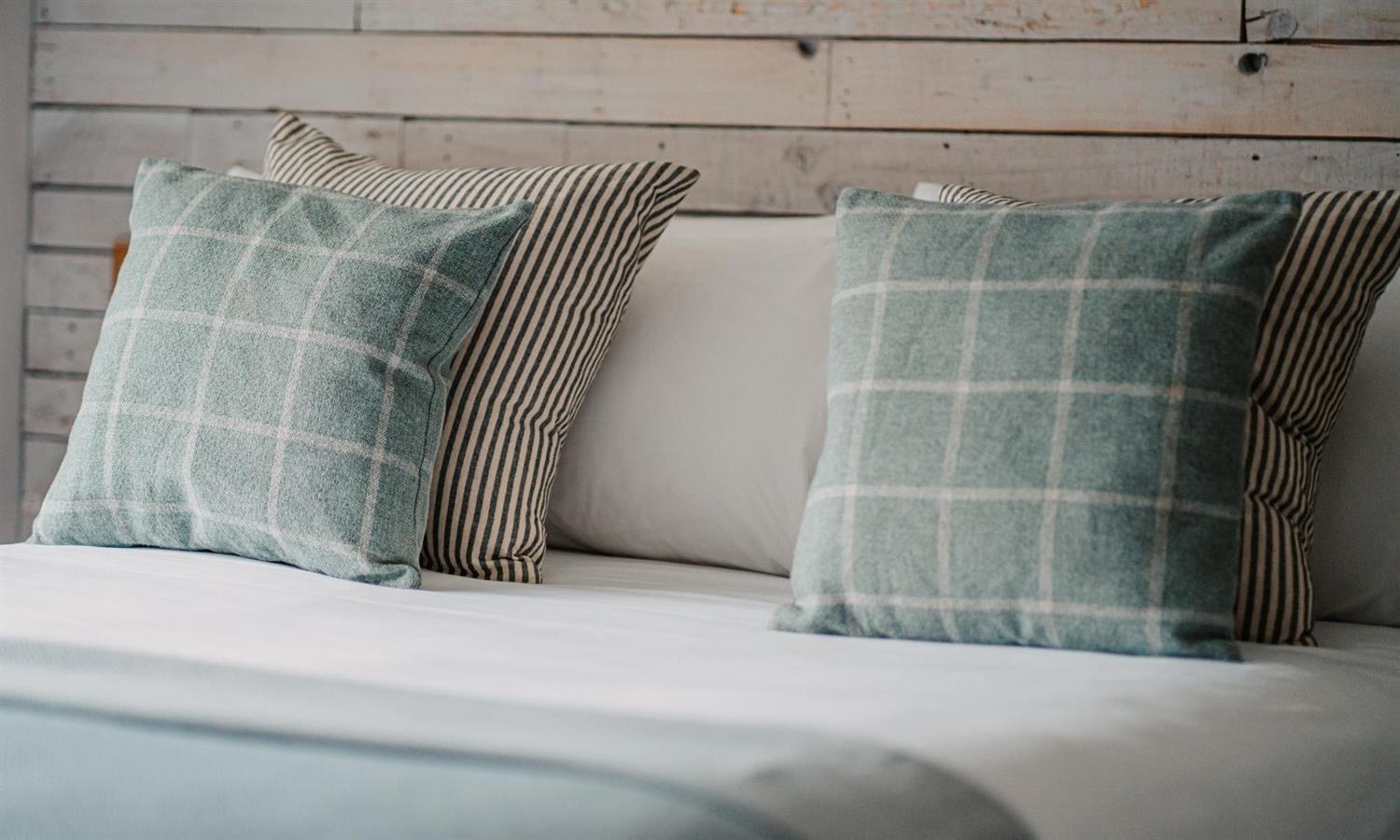 Cosy Double Bedroom at The Ship Inn with cushions on a bed