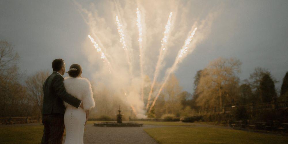 Couple watching fireworks at their wedding