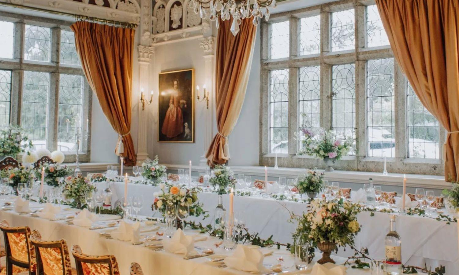 Orange and blue themed wedding breakfast set up in Lewtrenchard Manor ballroom