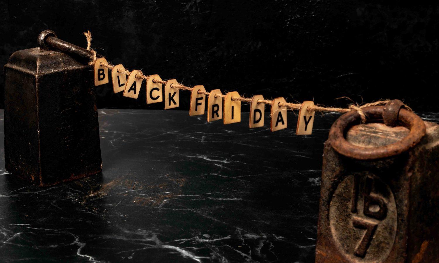 Letters spelling Black Friday on a string tied between two pound weights
