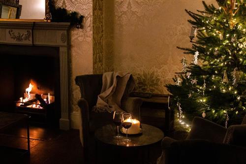 Christmas tree in front of a roaring open fire