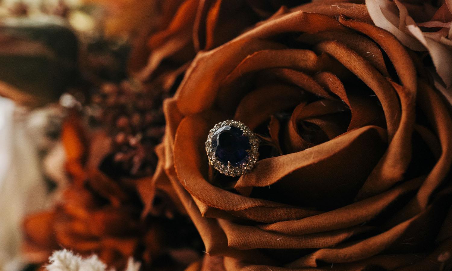Close up of red rose with jewelled ring inside it