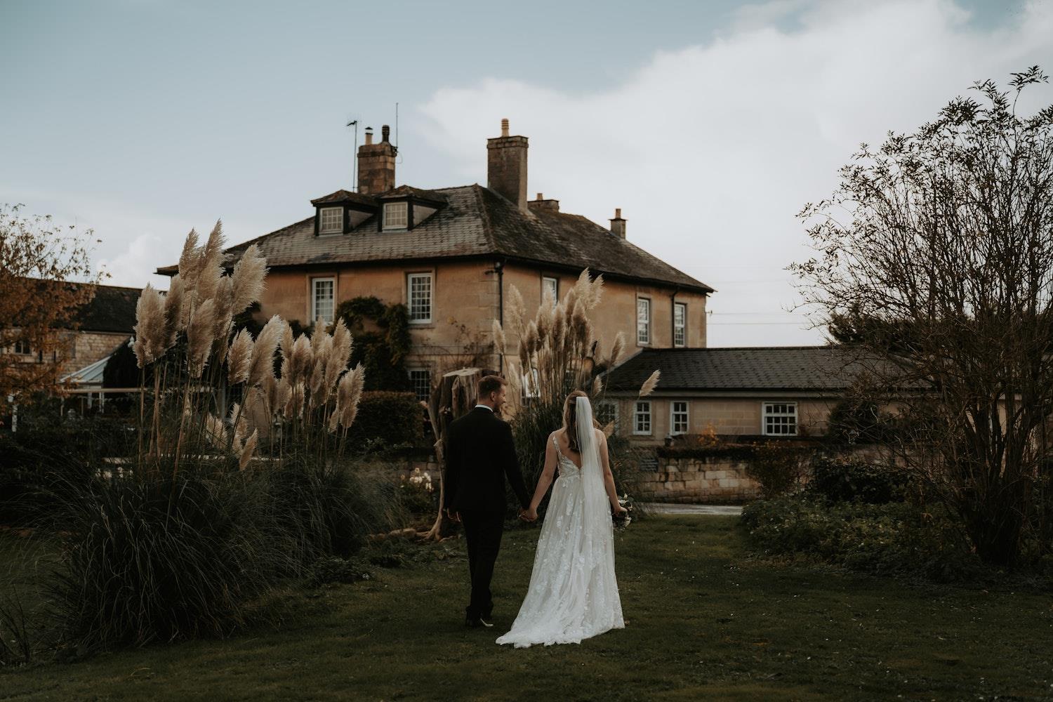 Bride & Groom walk towards Widbrook Grange (C) Amber Louise Photography