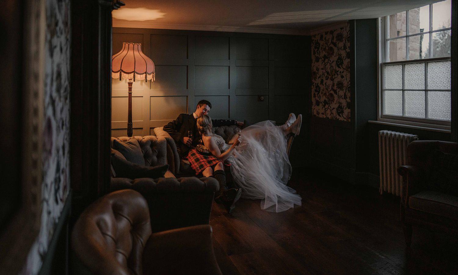 Bride and groom relaxing together in an intimate suite at castle wedding