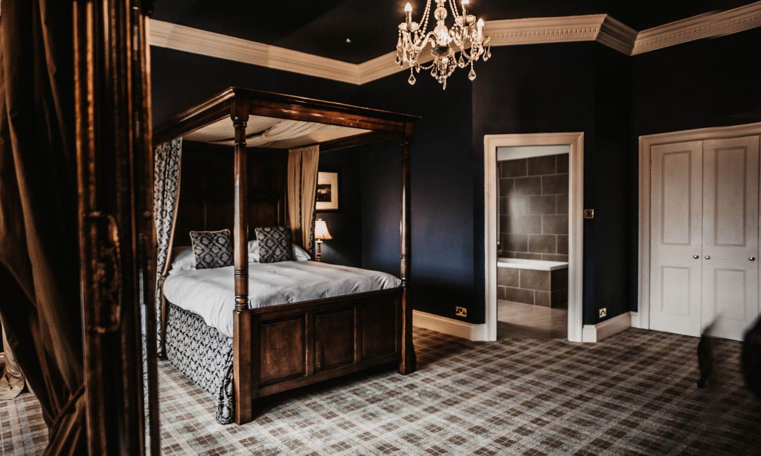 Luxury bridal suite with four-poster bed and chandelier