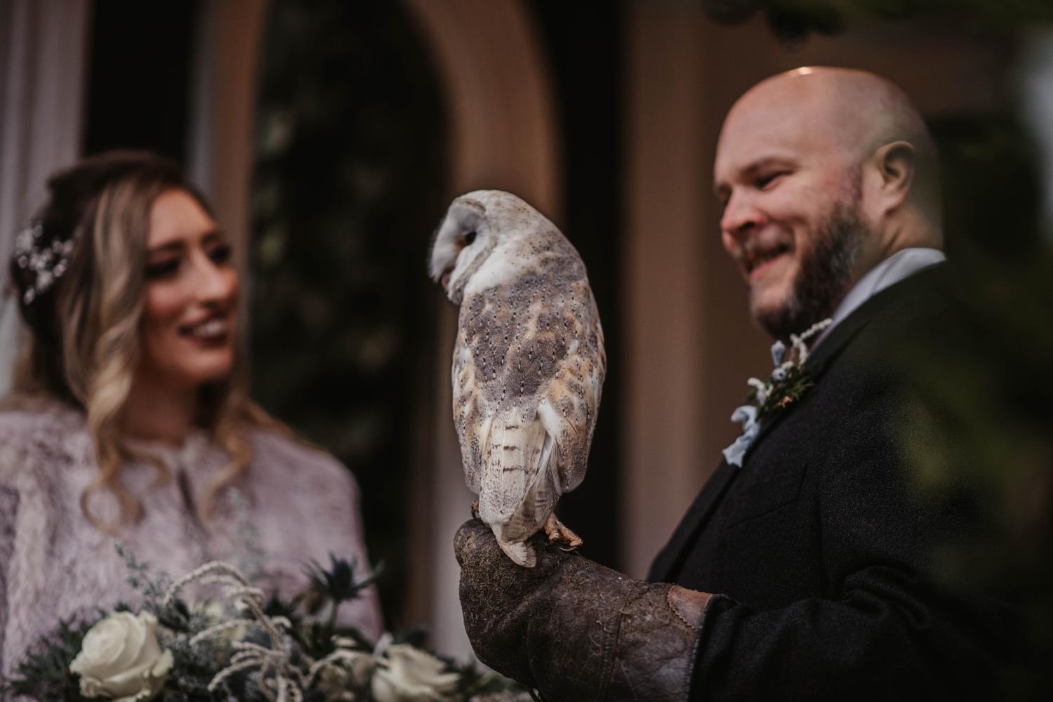 Bride and groom with barn owl