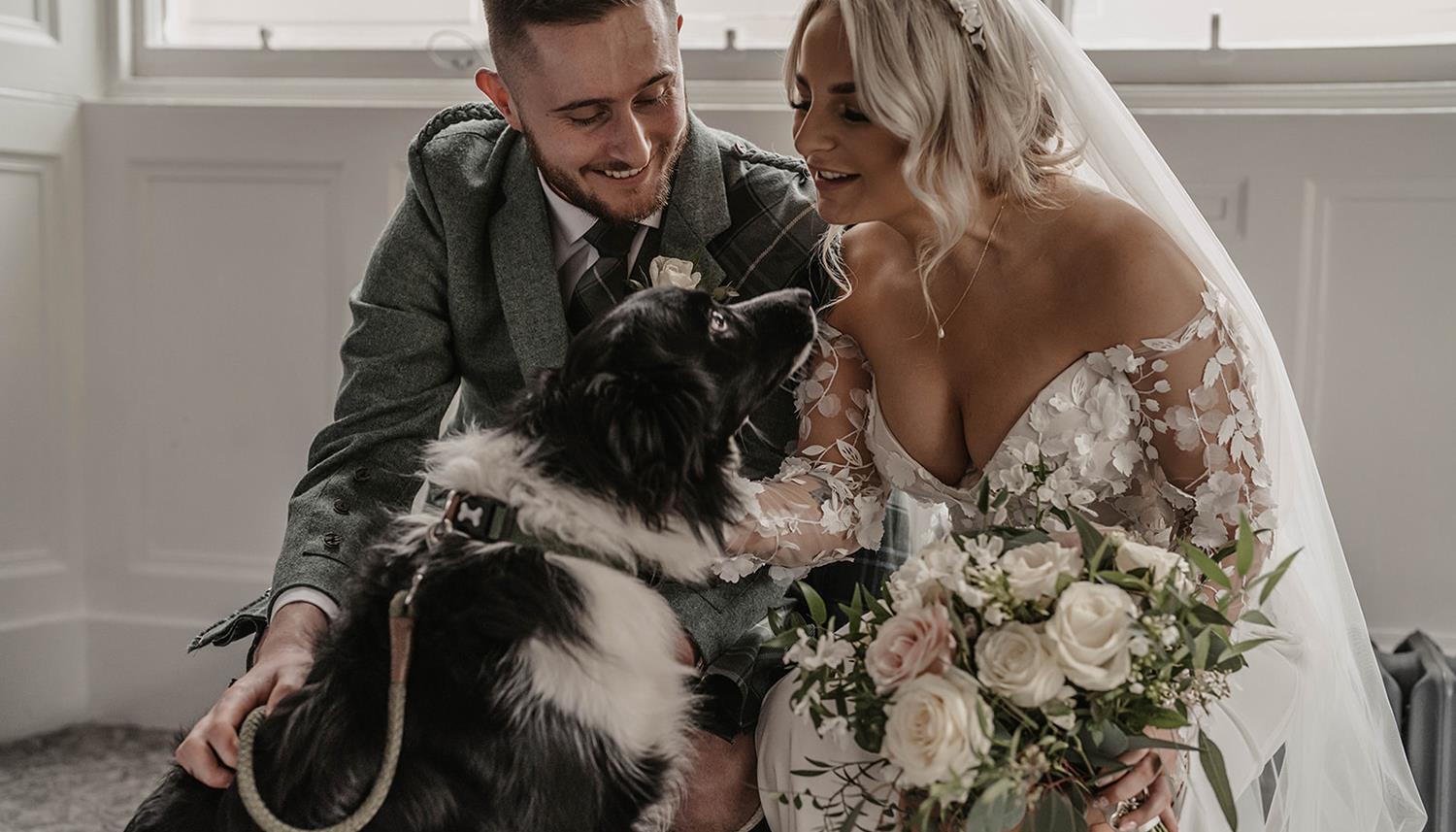 Bride and Groom petting the dog. Photo Credit: Willow and Wilde
