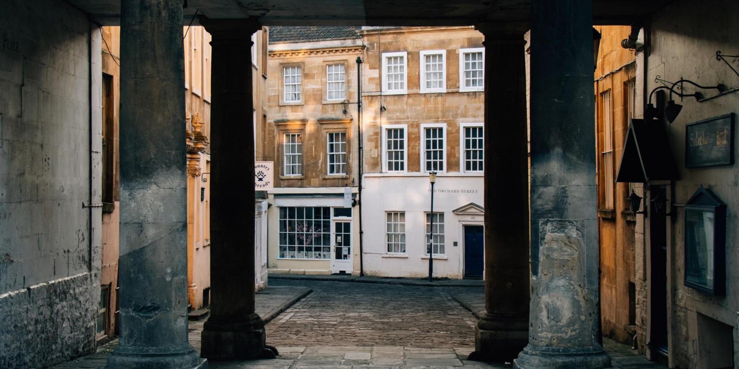 Street view of Georgian Bath through Greco-Roman columns