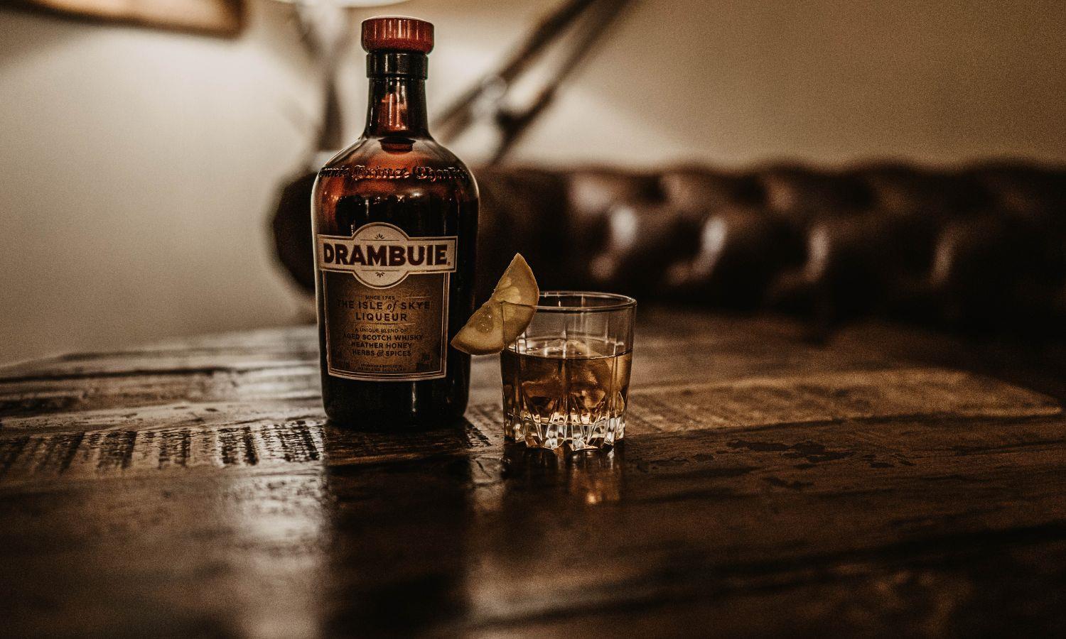 Bottle of Drambuie on table with drink next to it
