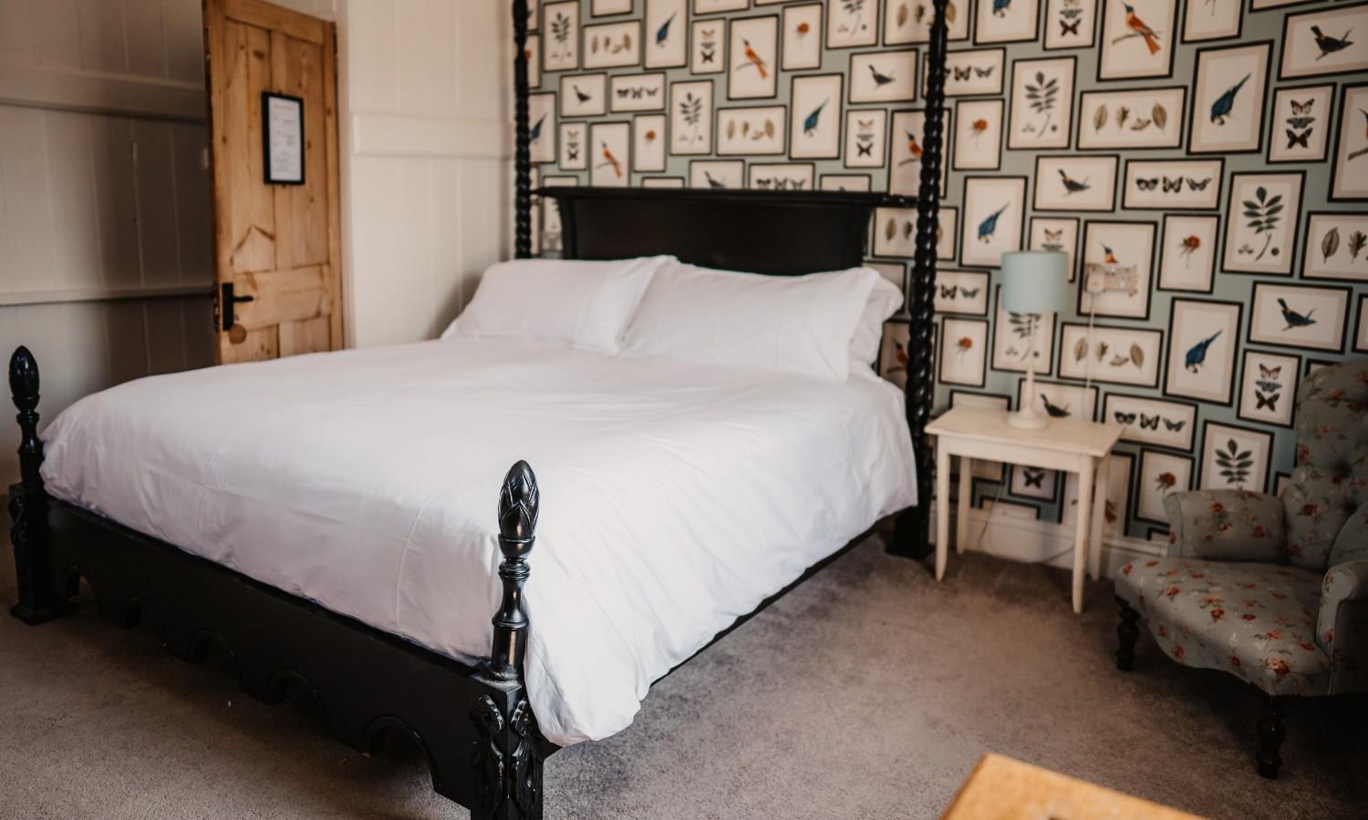 Boutique hotel bedroom with four poster bed and eclectic aesthetic