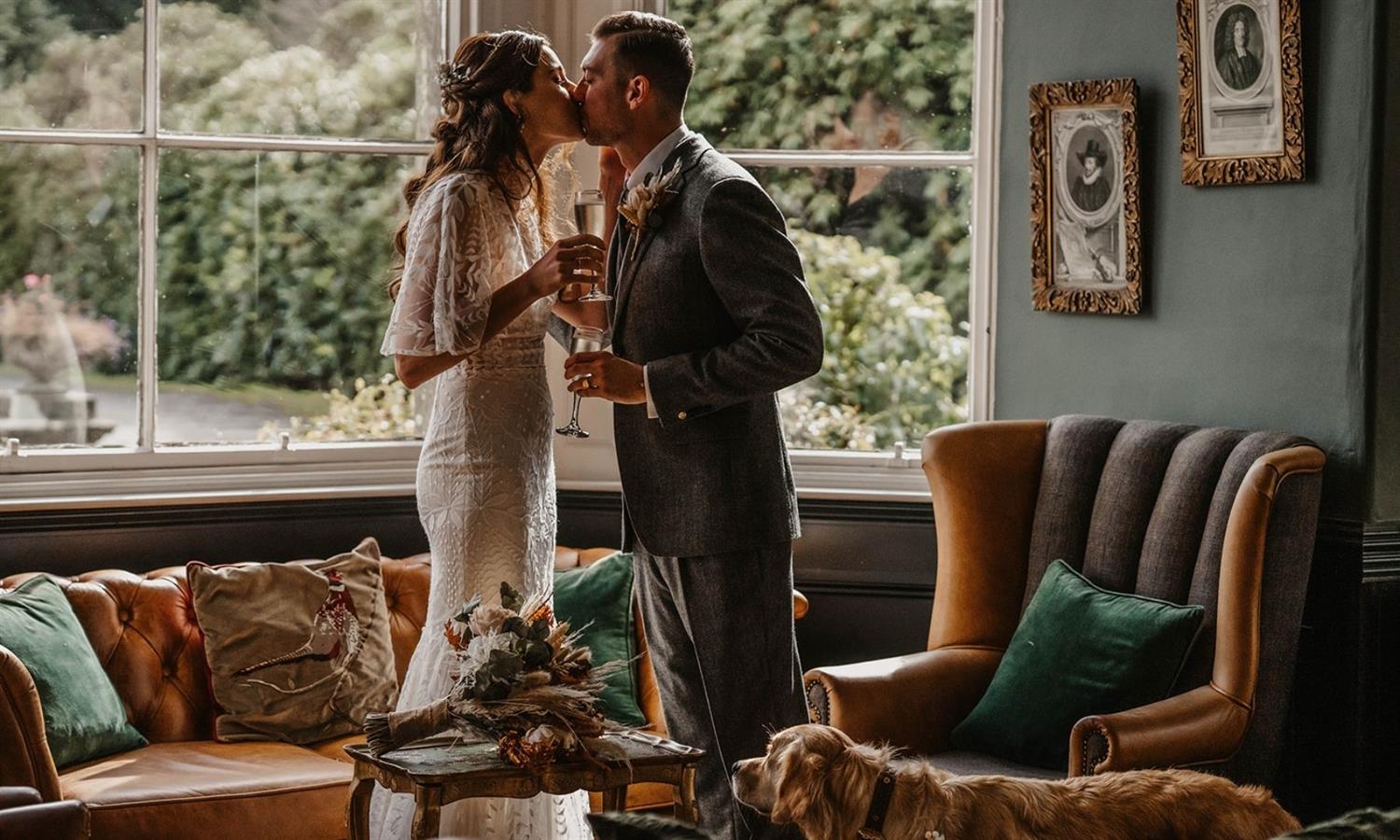 Bride and groom kissing in opulent lounge at Auchen Castle