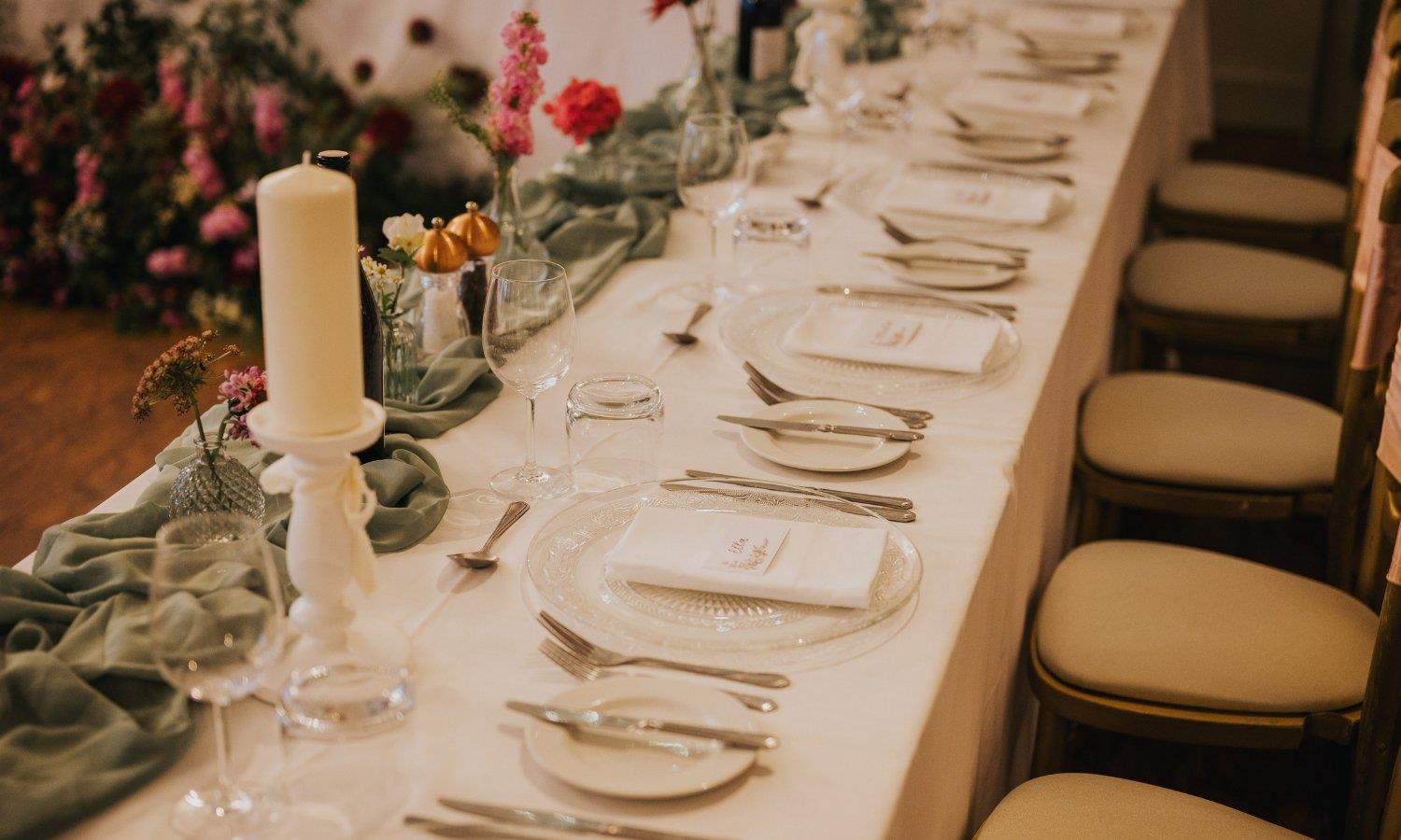 Tablesetting with floral arrangements and candles for wedding breakfast