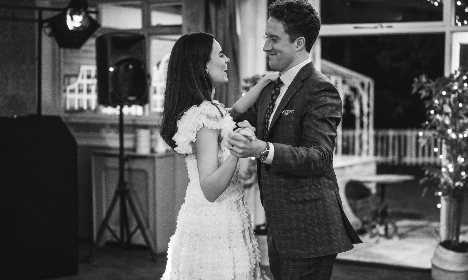 Romantic wedding couple dancing at hotel wedding venue