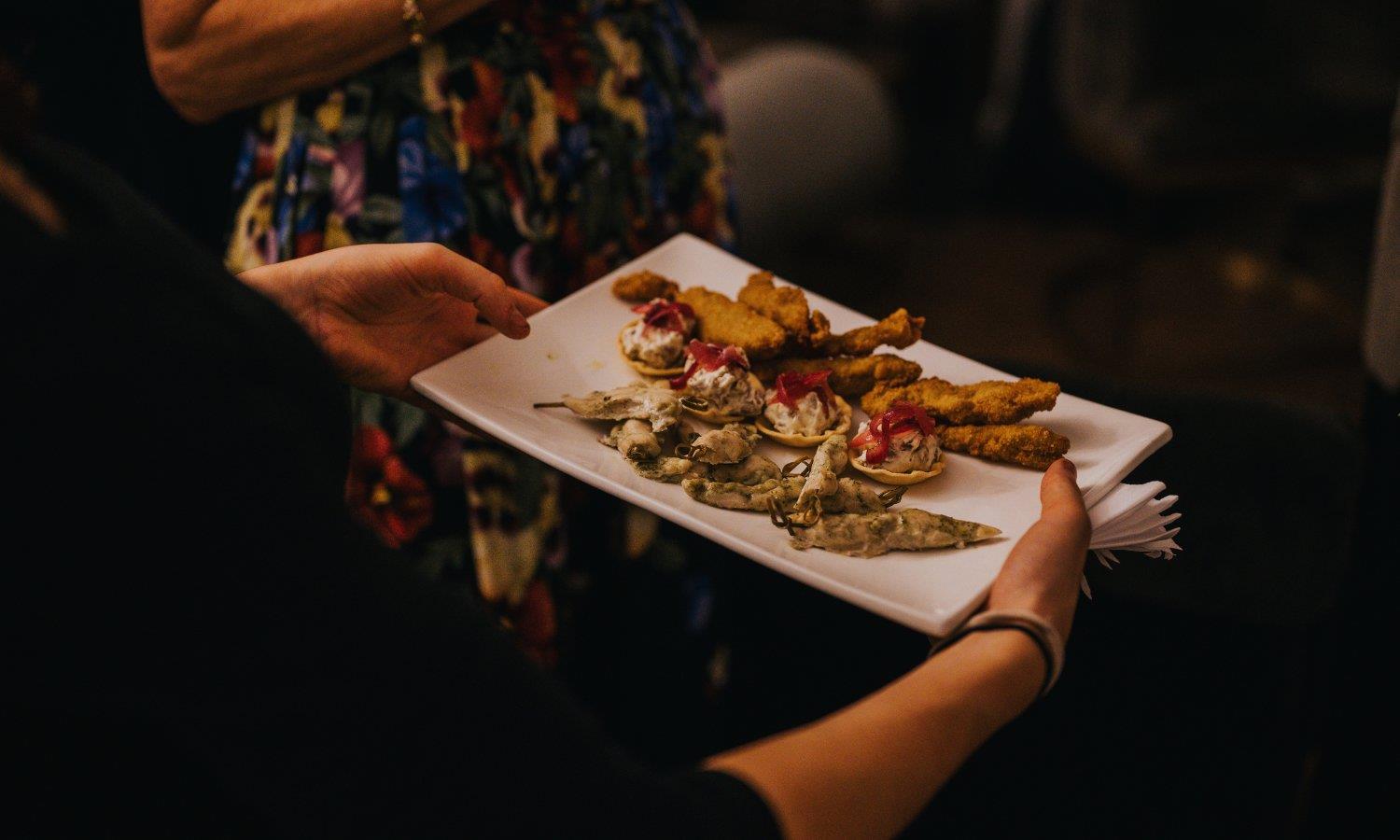 Varios wedding food being served on rectangular plate