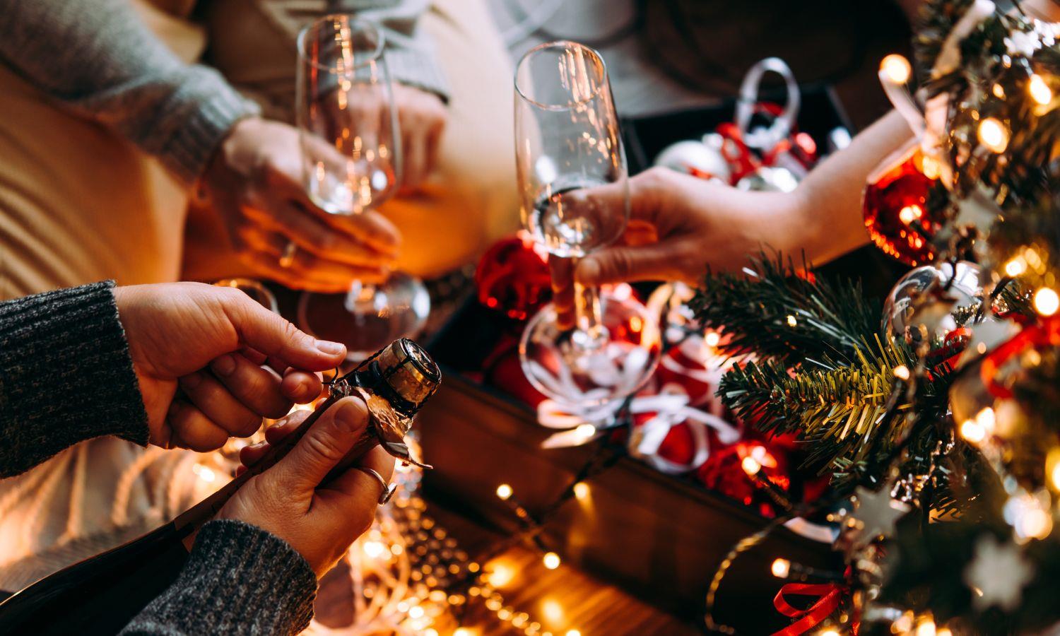 Champagne glasses held over Christmas decorations