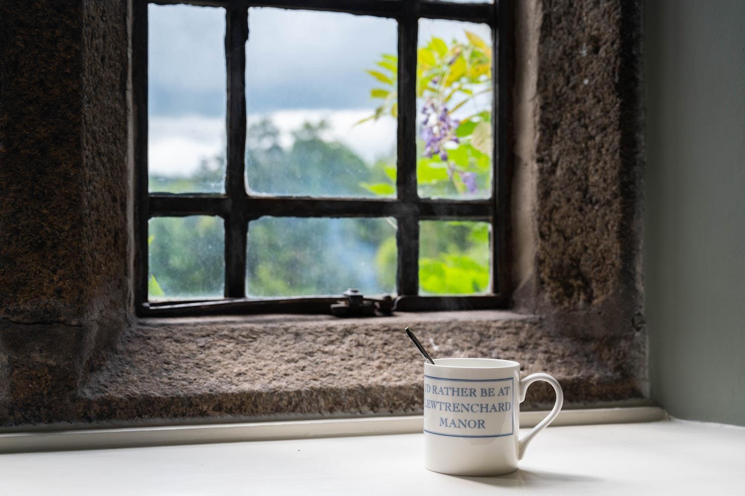 steaming coffee mug on window sill 