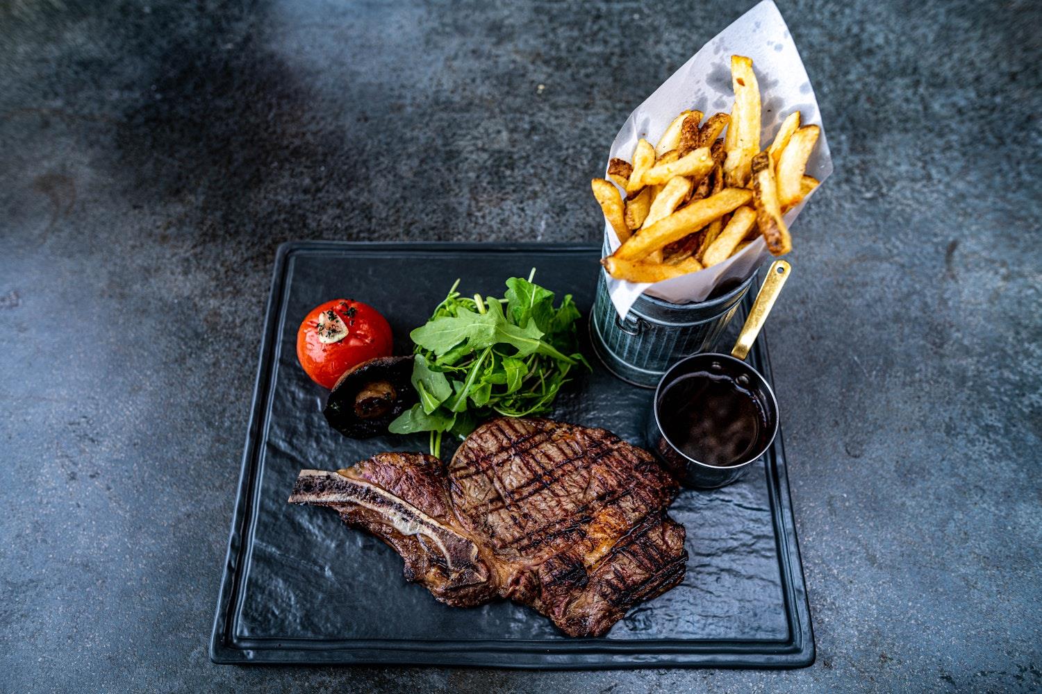 Steak and chips on a board at the Elephant Hotel