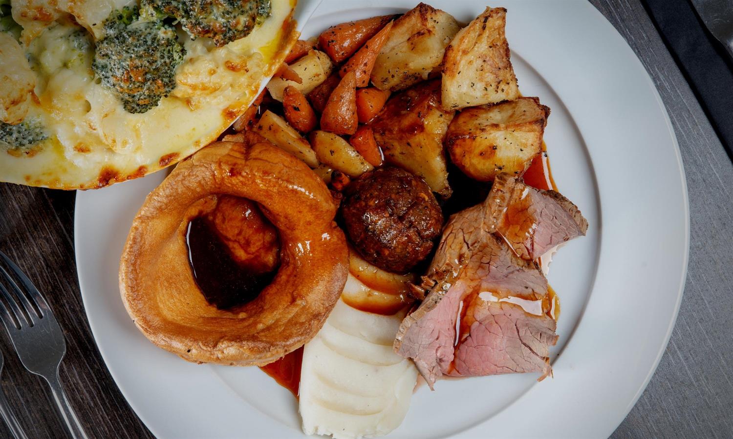 Roast Sunday lunch including roast beef, Yorkshire pudding and vegetables