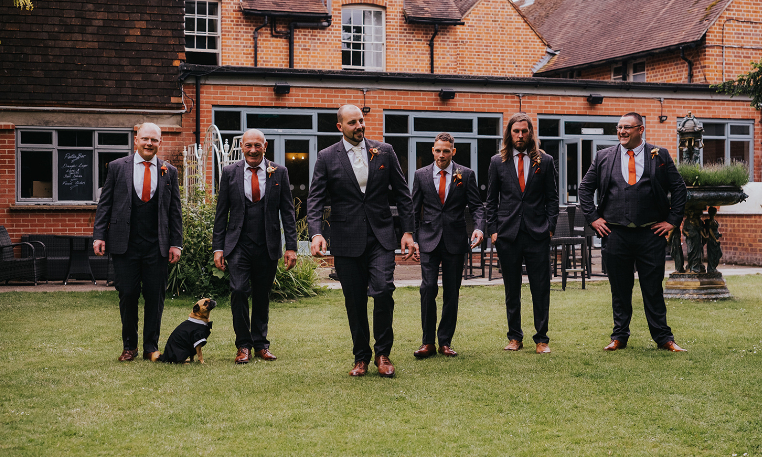 Groom's wedding party in wedding clothing with dog in wedding shirt