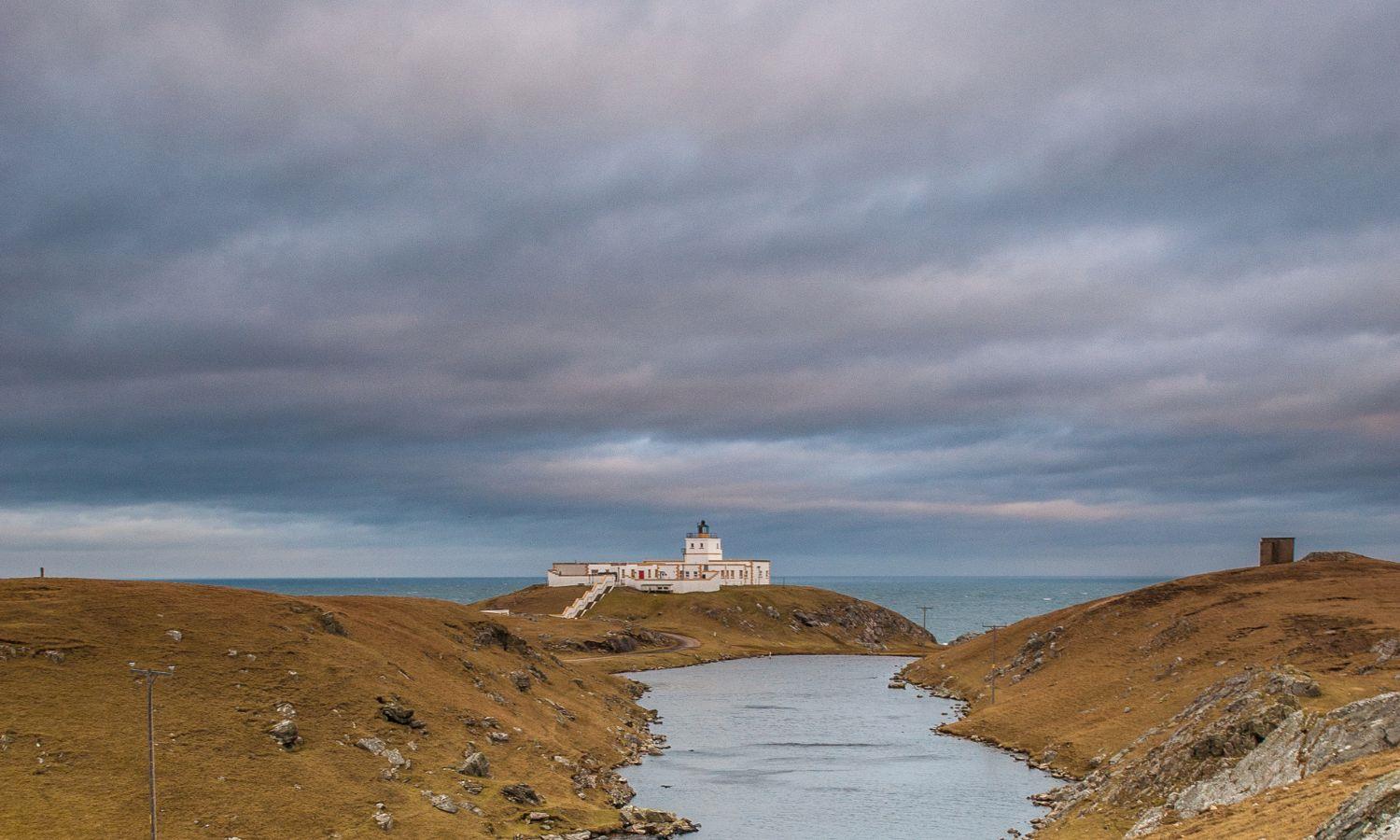 Lighthouse perched on rocky outcrop at Dunnet Head in Caithness