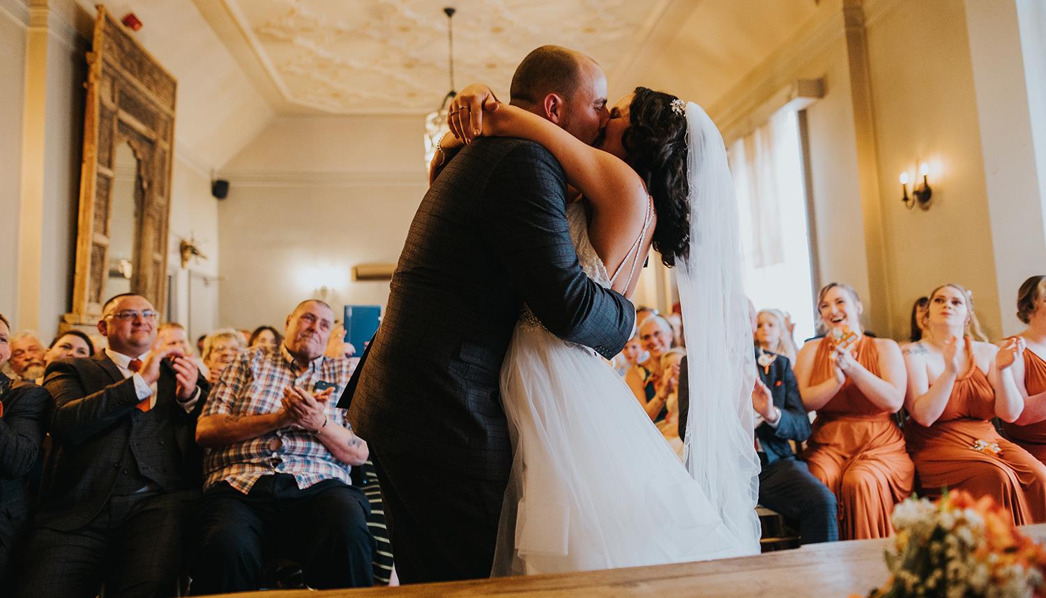Kiss the bride. Photo Credit: Charlie Bluck Photography