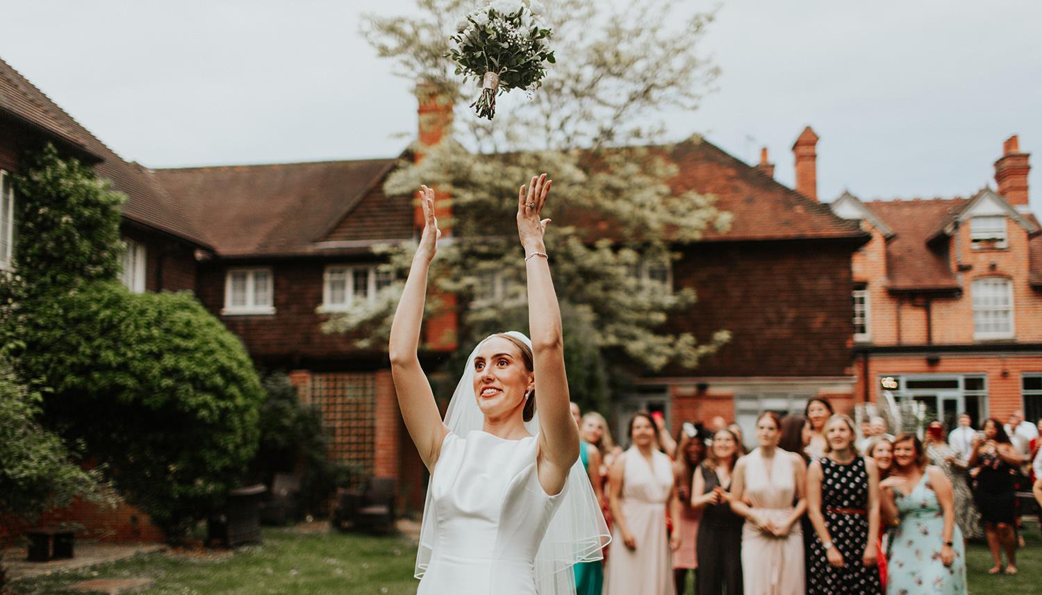 Throwing the bouquet. Photo Credit: Oxana Mazur Photography