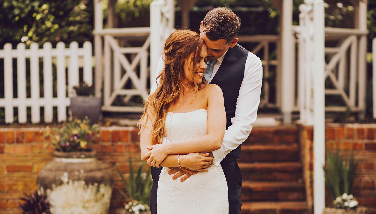 couple embrace at an outdoor wedding ceremony (c) DM Photography
