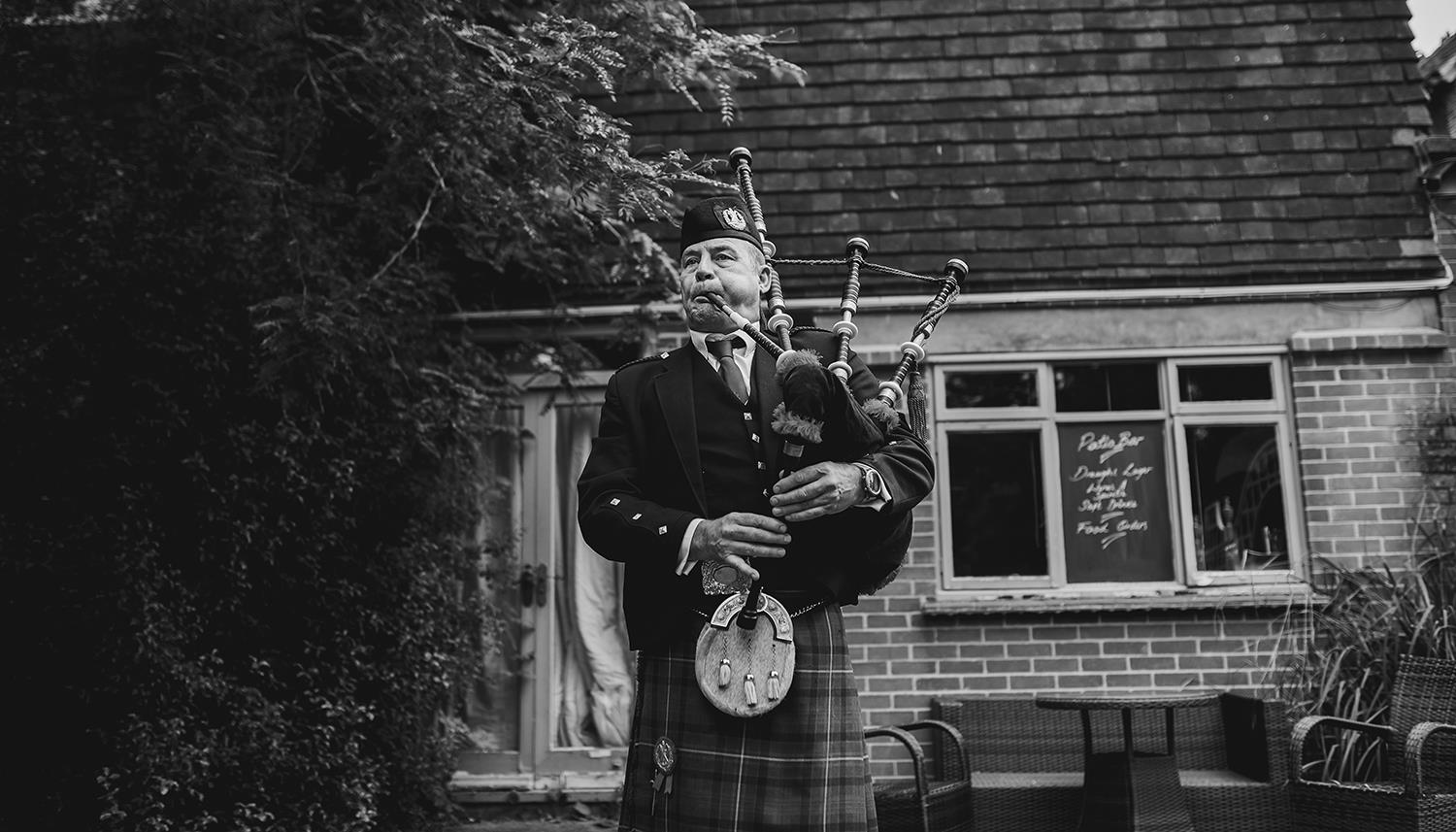 Bagpipes being played by man dressed in kilt. Photo Credit: Matthew Lawrence Photography