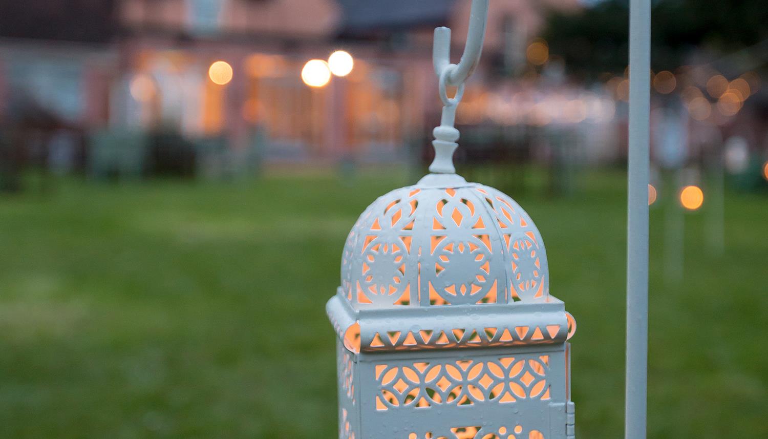 Lantern on hook placed outdoors. Photo Credit: Vevi-photography