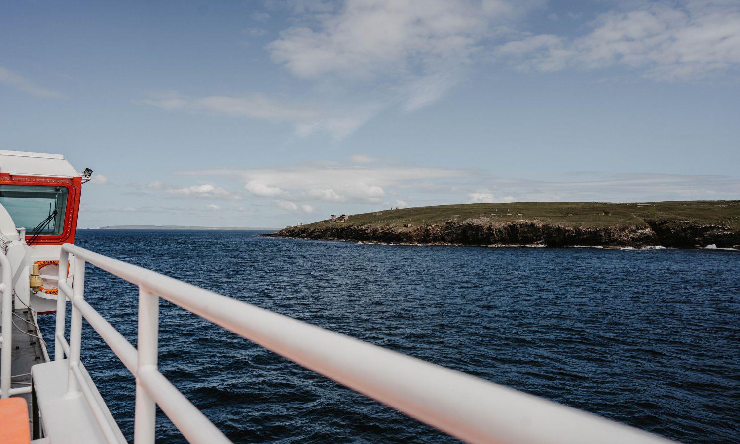 View of the sea over the guard rail from Orkney ferry