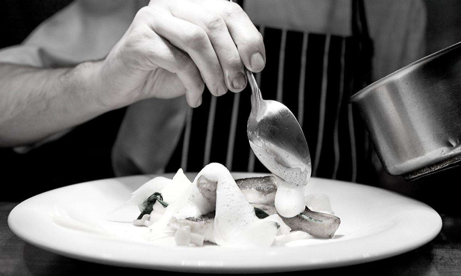 Chef in fine dining restaurant preparing food
