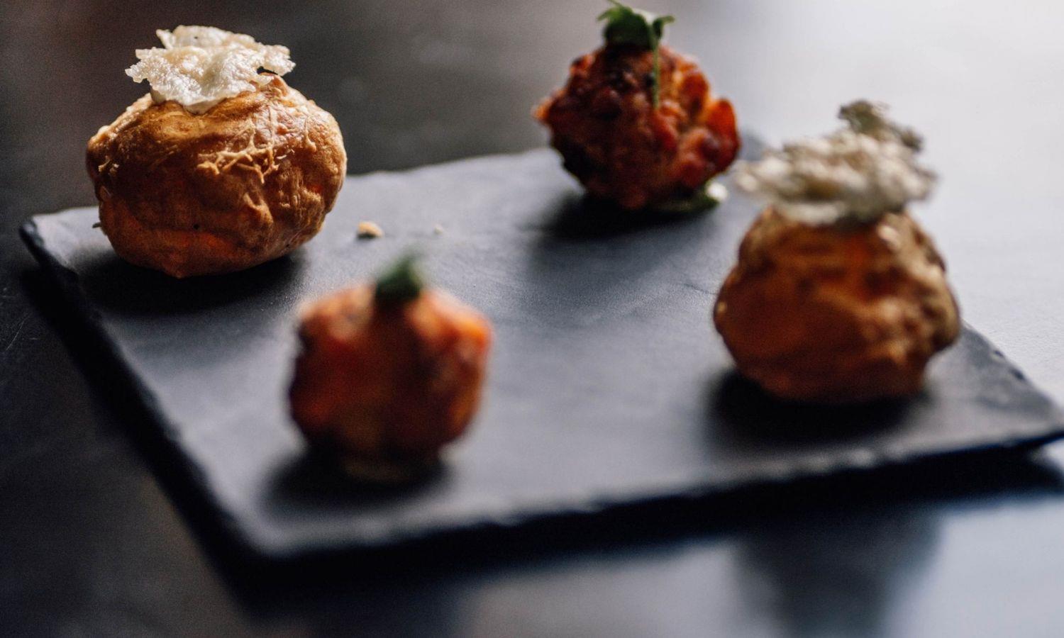Slate with four fine dining canapes