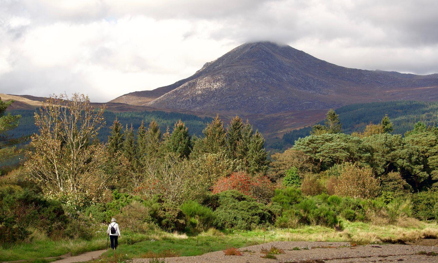 Hiker walking towards Goat Fell mountain on the Isle of arran