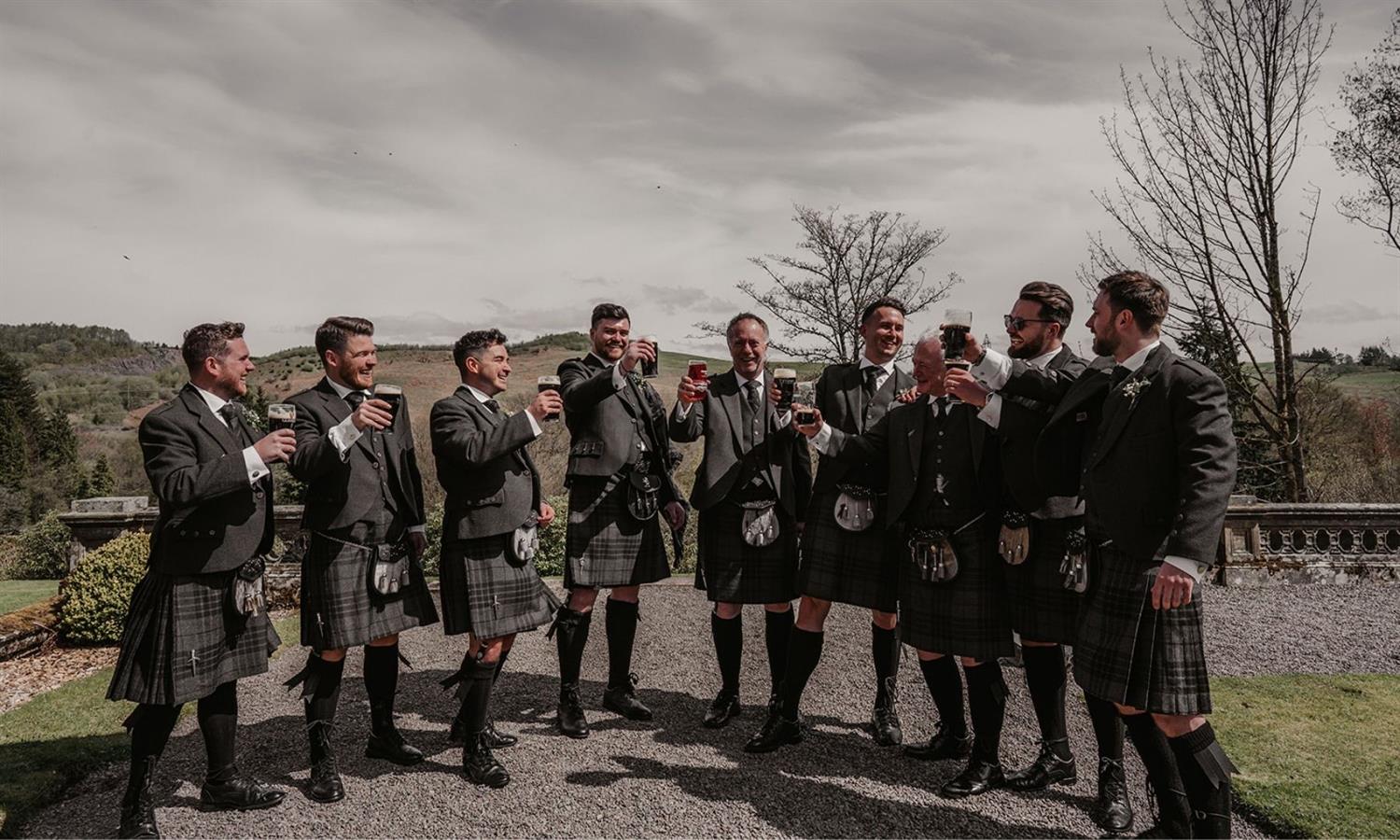 Party of groomsmen with drinks at Auchen Castle