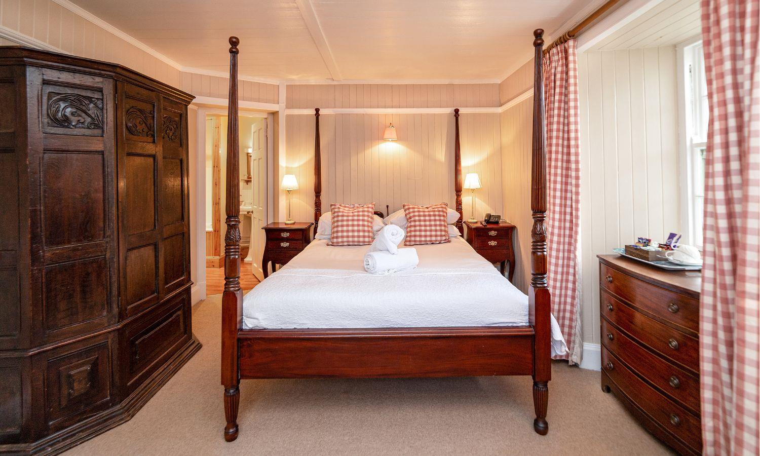Hotel bedroom with traditional styling and four poster bed