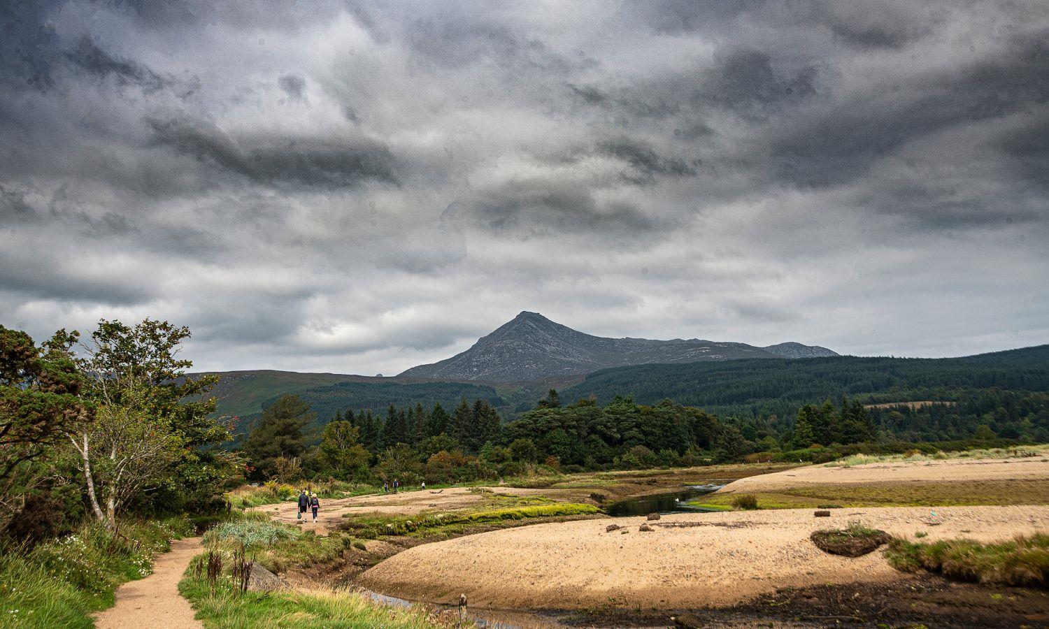 Hikers walking towards Goat Fell mountain on the Isle of arran