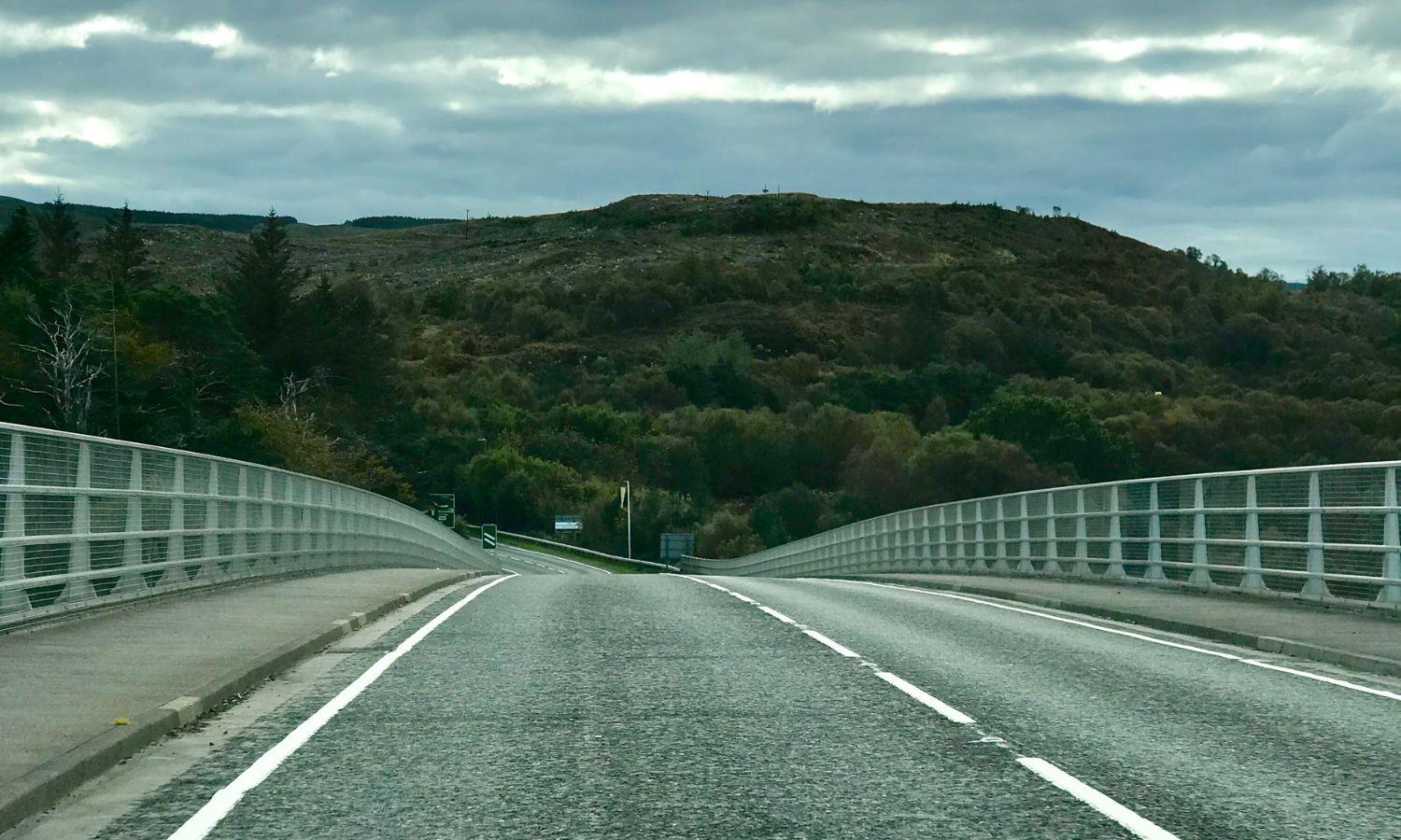 Driving across the Skye Bridge towards the Isle of Skye on a cloudy Highland day