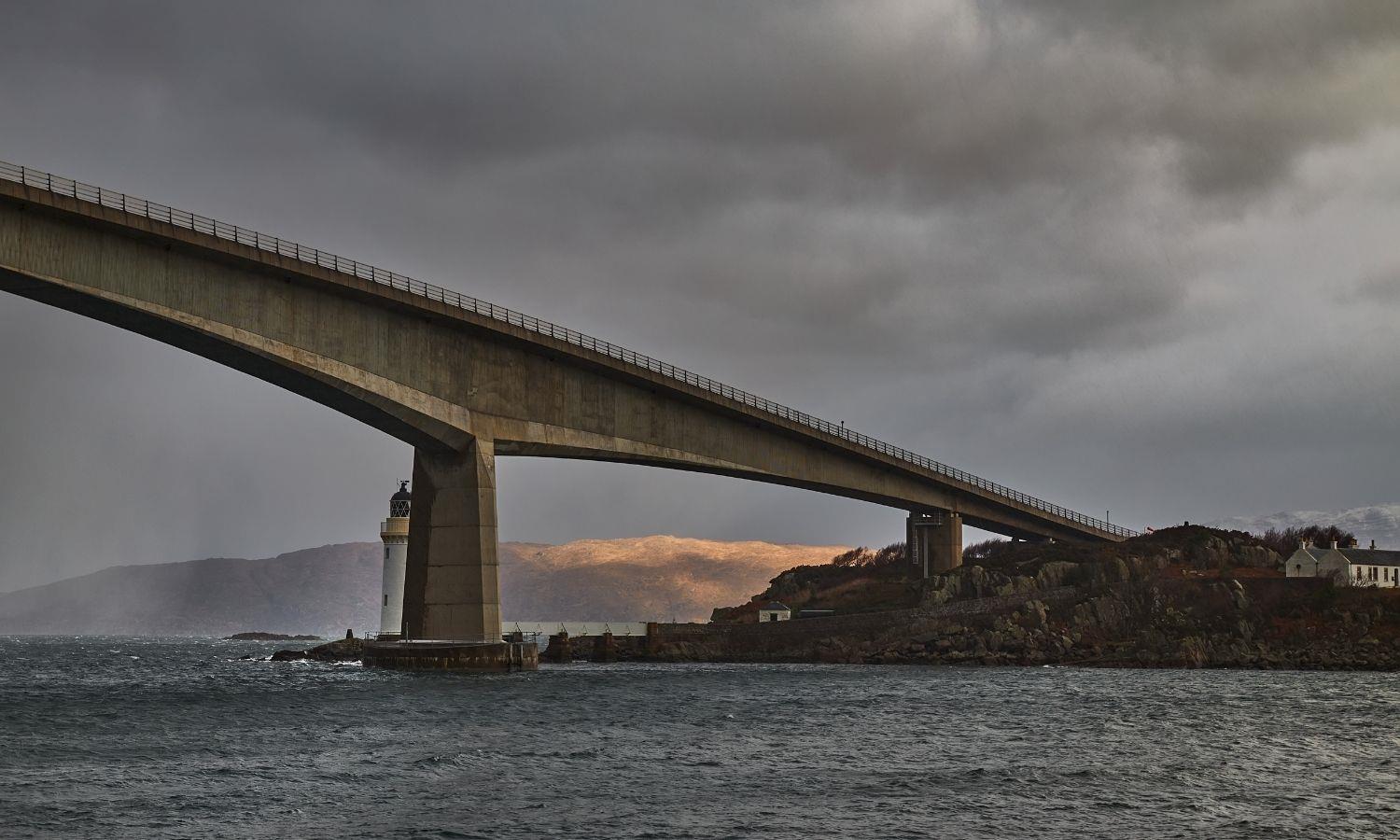 The Skye Bridge crossing Loch Alsh beneath dramatic storm clouds on the approach to the Isle of Skye