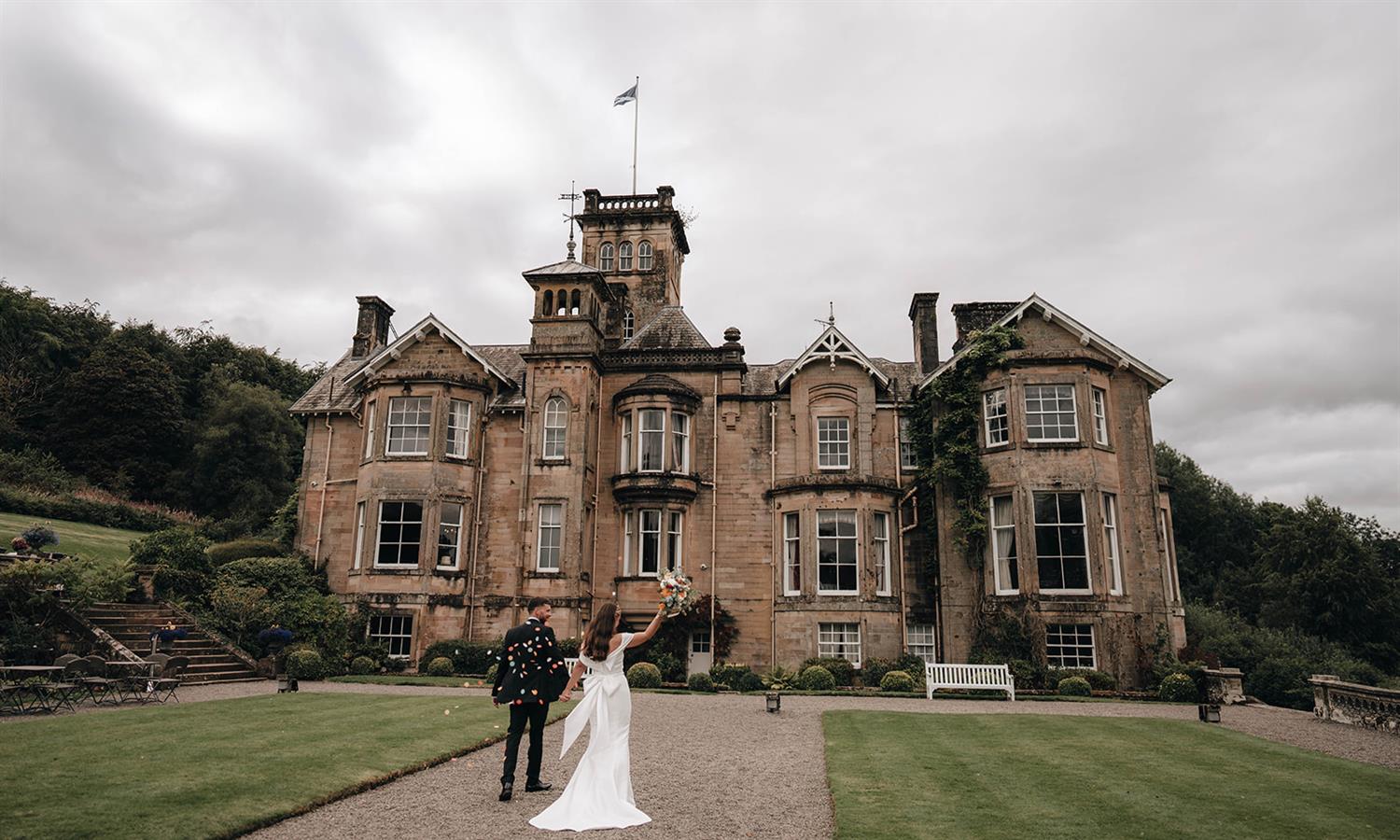 A happy couple outside the front of Auchen Castle