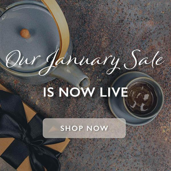 Gift boxe on a plain background with a tea pot and mug