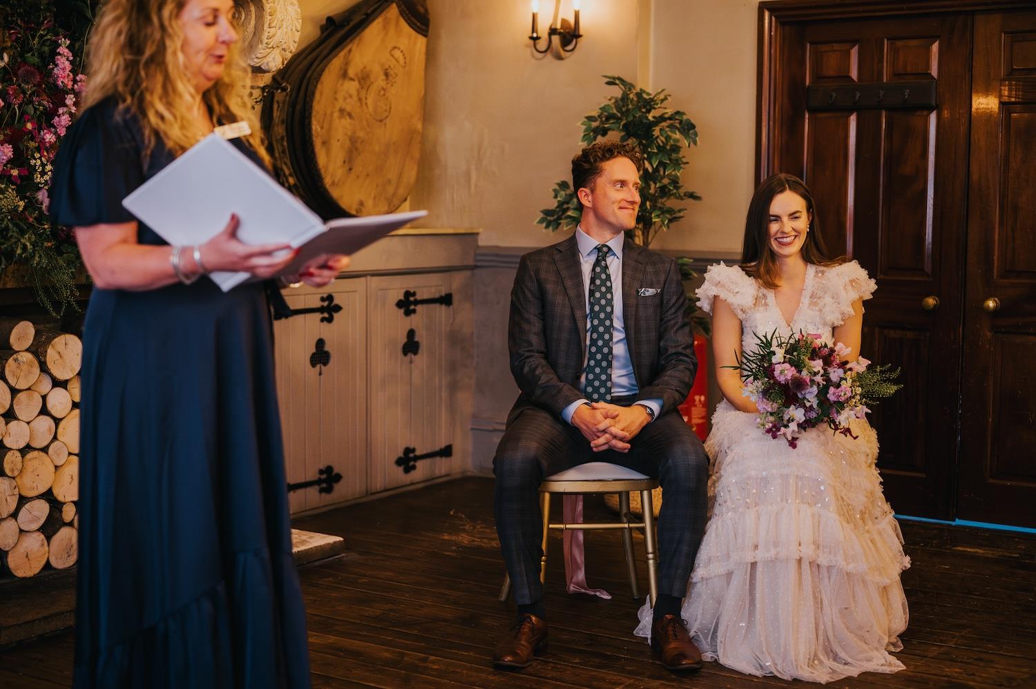 Newlywed bride and groom kissing surrounded by guests holding sparklers