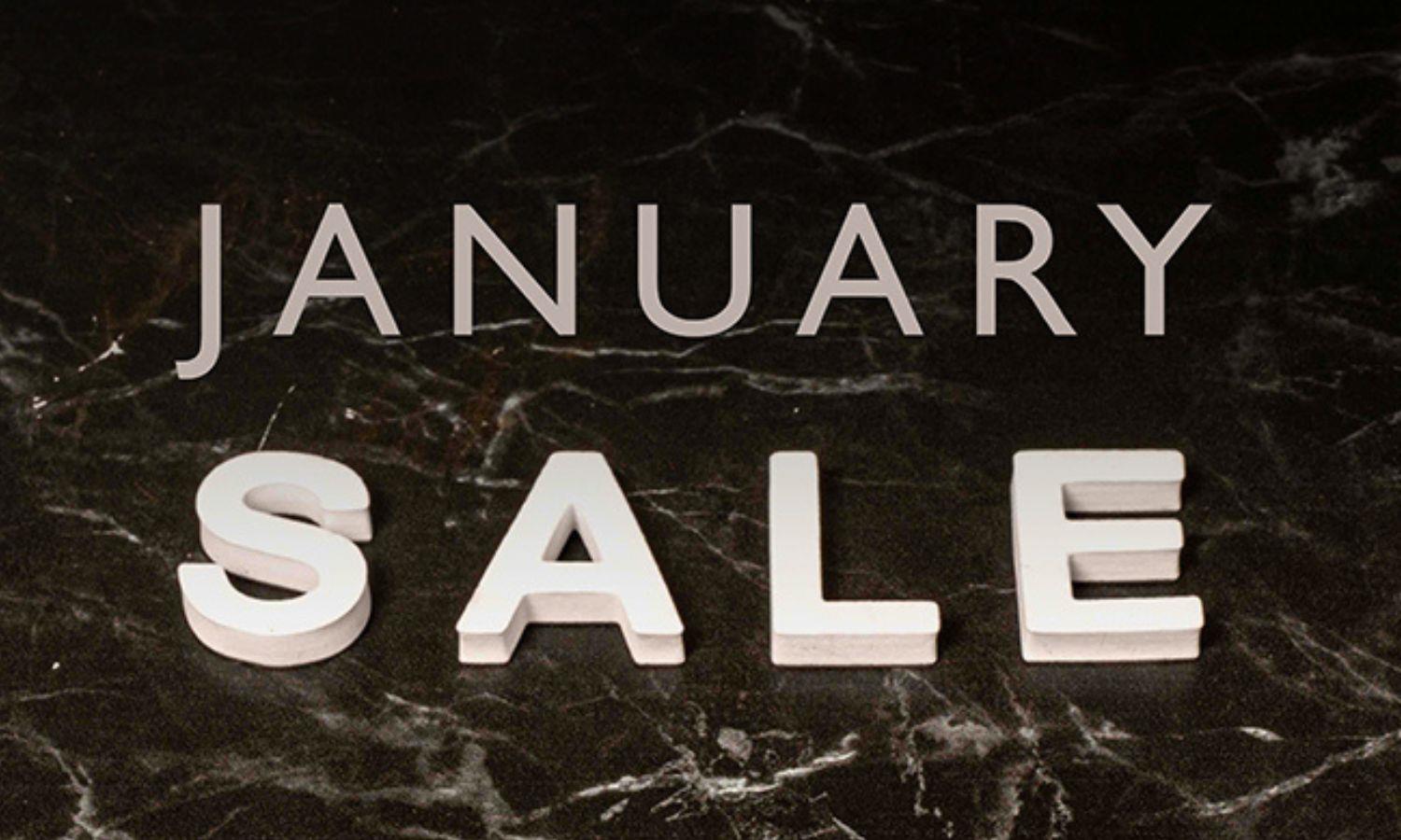 Text reads January Sale on a textured black and white background