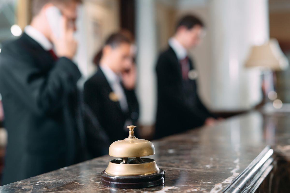Bell on front of house desk with reception team in background
